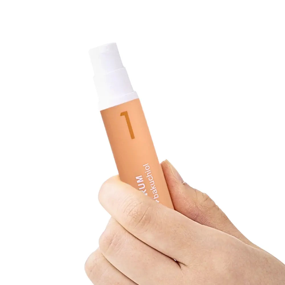 Hand holding KDL Viva Vitamin Serum for brightening and revitalizing dull skin.
