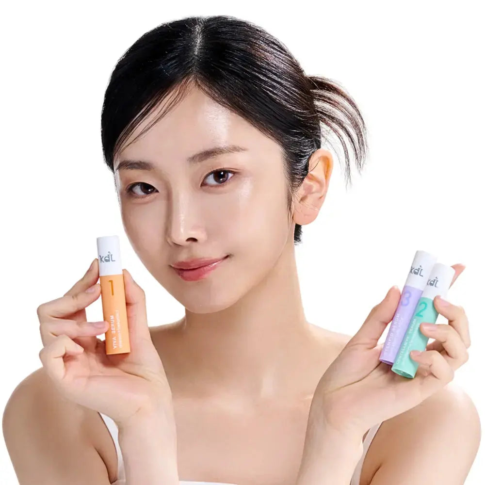 Model holding KDL Centellieve Serum that helps calm, hydrate, and balance the skin.