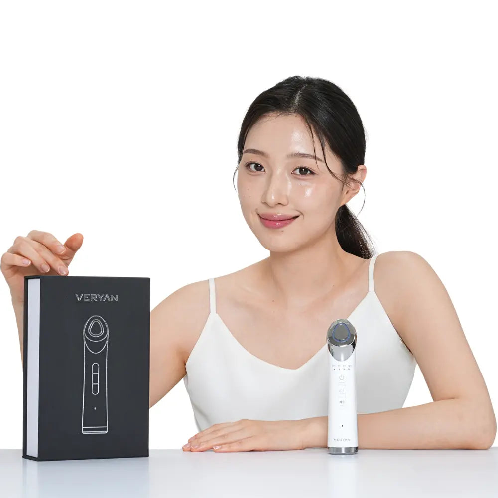 Lifestyle image of model presenting VERYAN home skincare device for lifting and rejuvenation treatments.