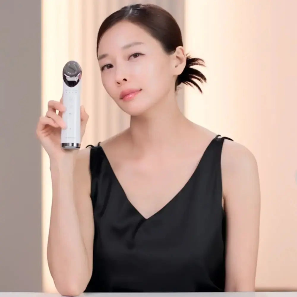 Woman holding the VERYAN PRO Korean beauty-tech device for professional-inspired facial care at home